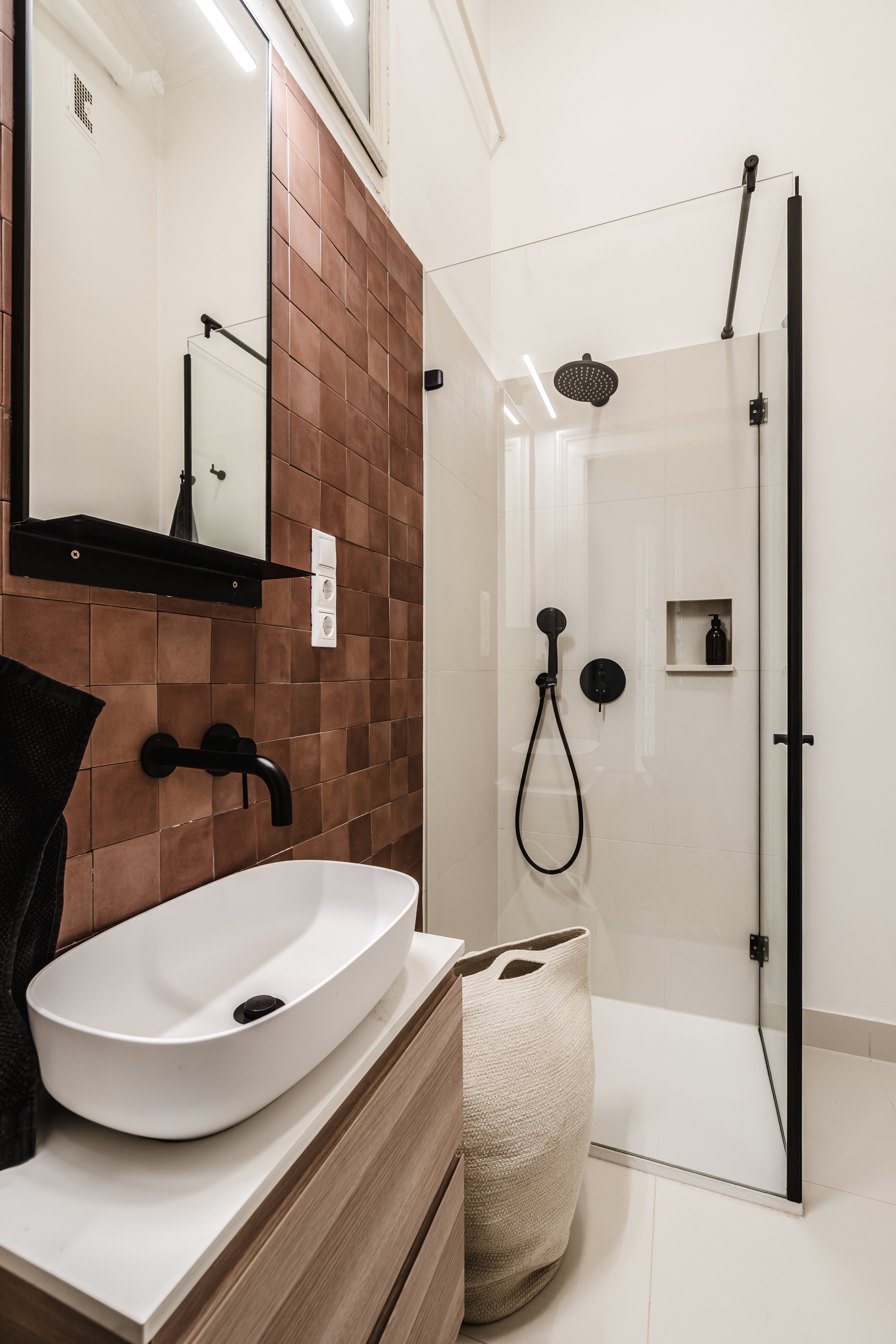 Modern bathroom with terracotta tiles and black fixtures