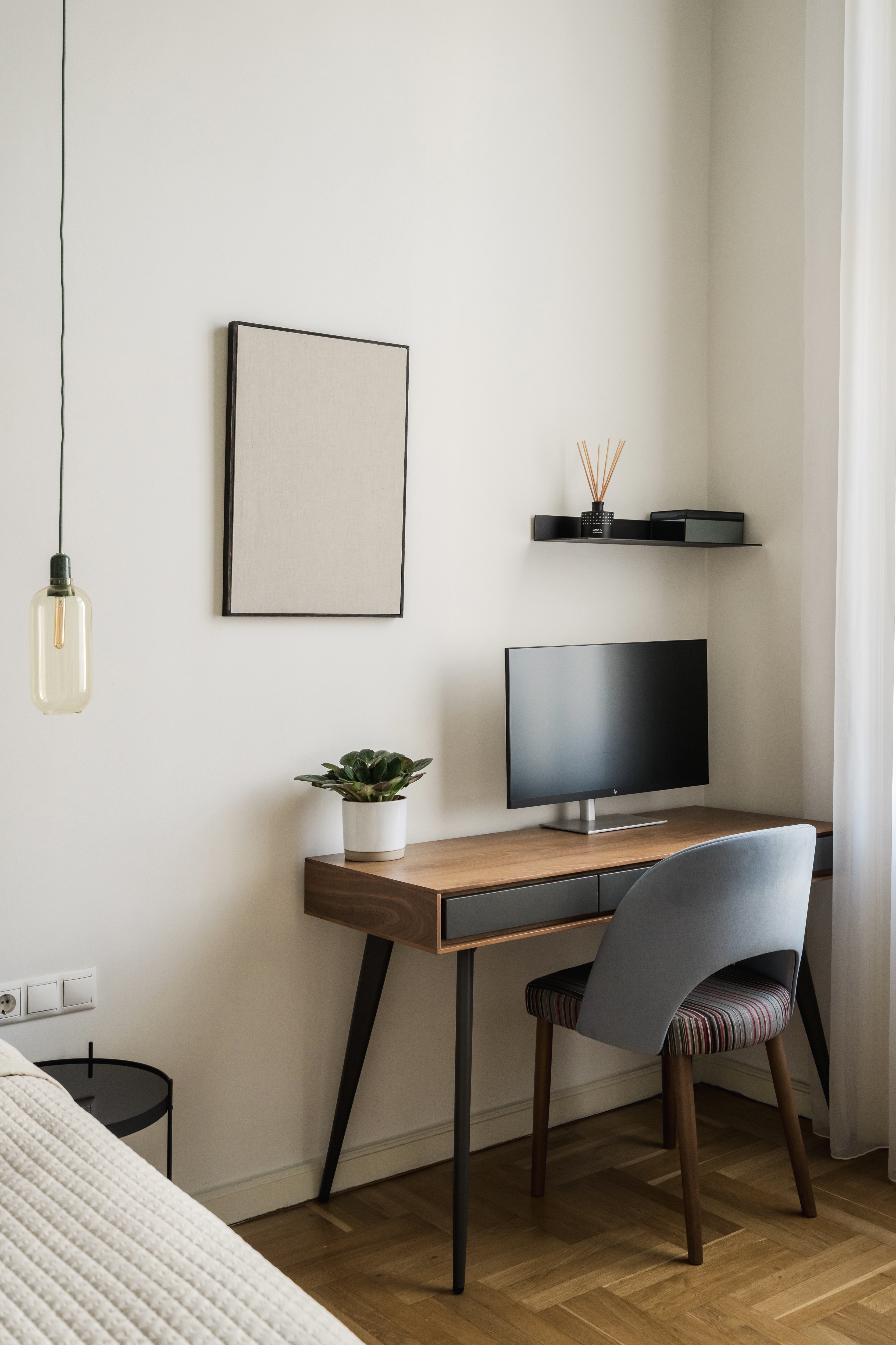 Bedroom workspace with mid-century desk and pendant light